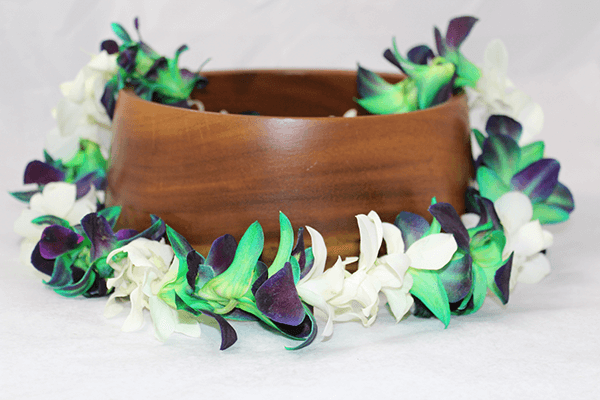 green tinted orchid flowers with white orchids lei