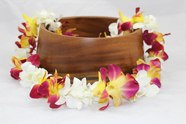 yellow tinted orchid flowers with white orchids lei